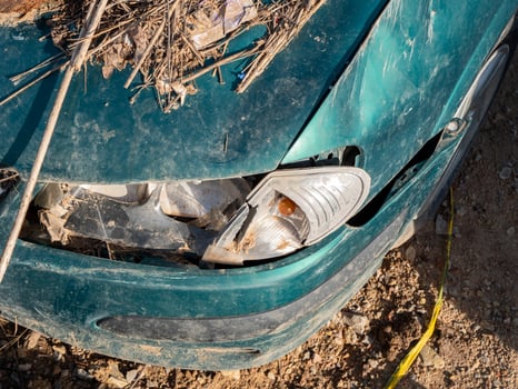close-up damaged, flood-affected car enveloped in layers of mud and debris. Great for topics on disaster aftermath and city resilience photo