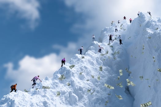 Climbers ascend snowy peak with scattered money under bright blue sky during day photo
