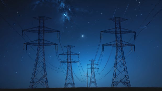 Power lines silhouetted against a starry night sky near an open field photo