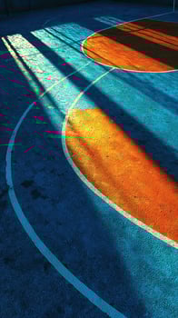 Bright colors and long shadows on an outdoor basketball court during late afternoon photo