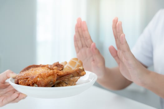 Beauty slim female body confuse fried chicken. Woman in restaurant achieves weight loss goal for healthy life, crazy about thinness, thin waist, nutritionist. Diet, photo