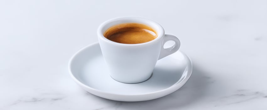 The elegant espresso cup on a minimalist white marble table. photo