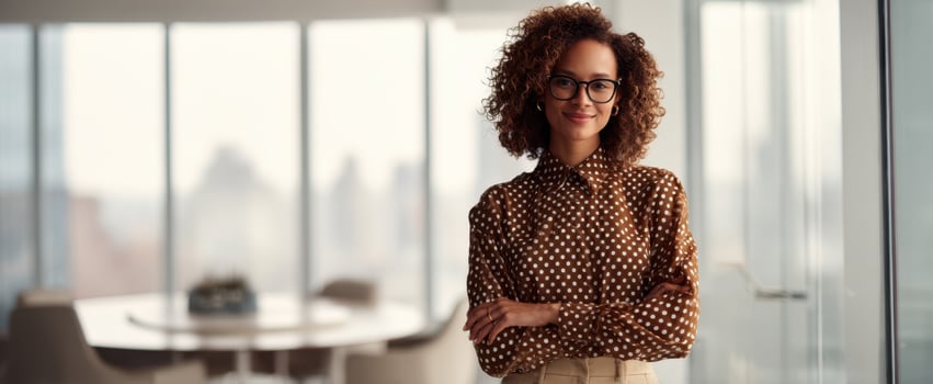 The confident woman standing in a modern office with a welcoming smile. photo