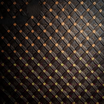 A black and gold patterned wall with a diamond pattern photo