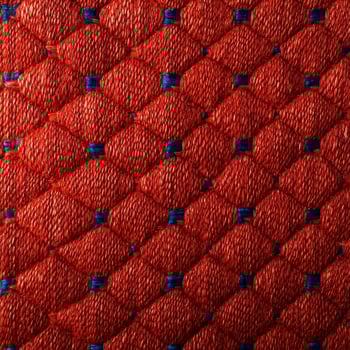 A close up of a red and blue woven fabric photo