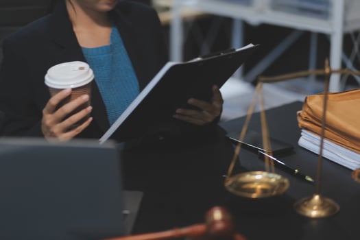 Lawyer working at desk with coffee and documents photo