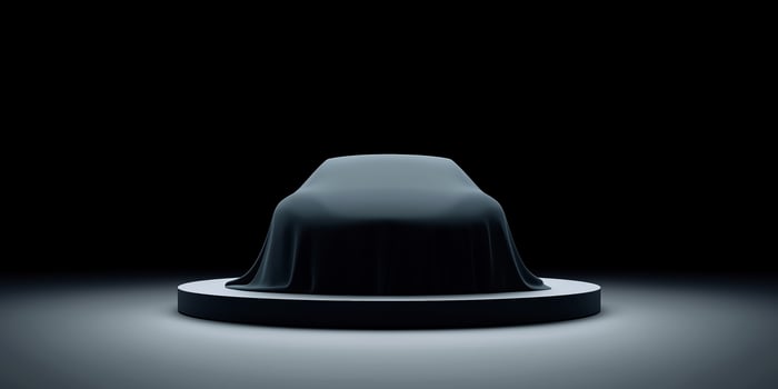 Mysterious covered object on a circular platform illuminated by soft light in a dark environment showcasing anticipation and intrigue concept photo
