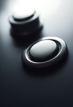 close up of a button on a black surface photo