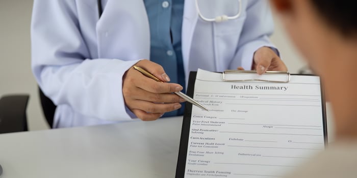 Health and Wellness. Doctor reviewing health summary with patient. photo