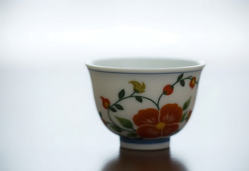 white and blue cup with flowers on it photo