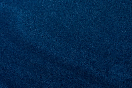Fine-grain dark blue sand texture with subtle gradients, ideal for backgrounds and design overlays. photo