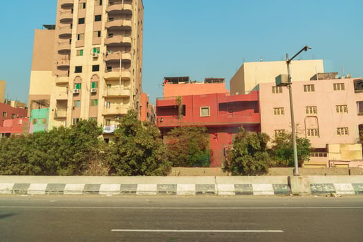Urban landscape showcasing colorful buildings along a highway in Cairo during daylight hours photo
