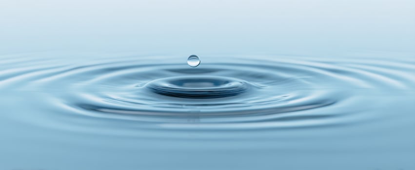 The Elegance of Water Droplets Creating Ripples on a Calm Surface photo
