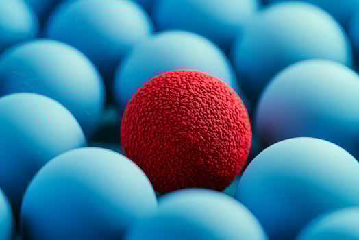 Red ball standing out from the crowd of blue balls photo