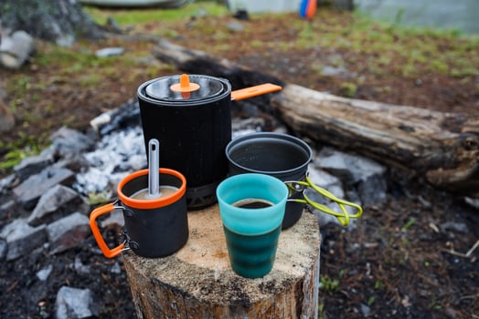 Camping Kitchen Setup Essential Cookware and Cozy Cups around the Campfire to Enhance Your Overall Outdoor Experience and make your adventure enjoyable and memorable as you explore nature photo