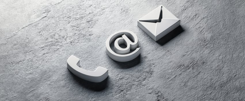 The digital communication symbols of phone, email, and at sign on a surface. photo