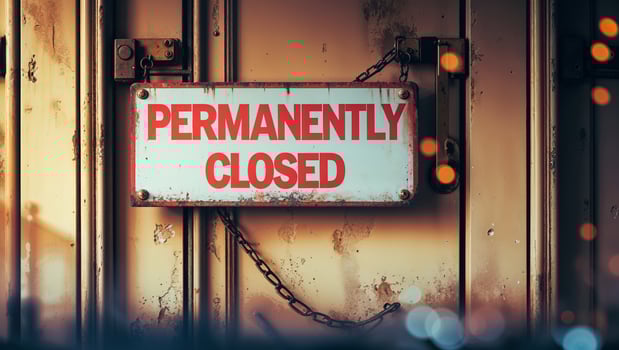 Business location displays permanently closed sign indicating cessation of operations in urban setting photo