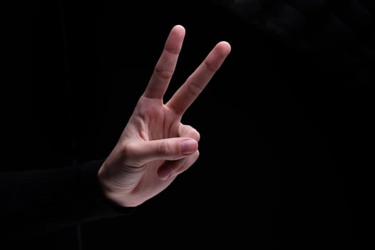 Woman's hand showing two fingers up, . Peace, fight, victory symbol, letter V in sign language or number two or second photo