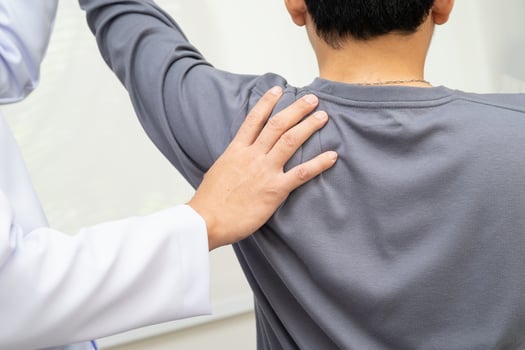 Physical therapy therapist doctor treat perform pain young man in hospital. photo