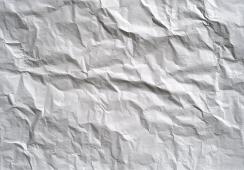 Crumpled Sheet of Paper Texture Close Up Shows Abstract Detail with Wrinkled Design Surface and Interesting Pattern for Creative Background Design photo