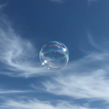 A soap bubble floating in the blue sky photo
