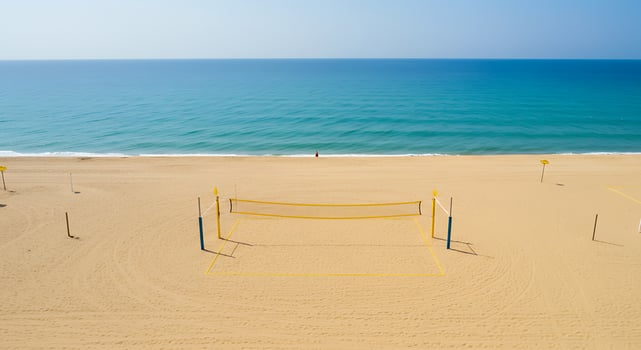 A volleyball net on a beach with a beach ball photo