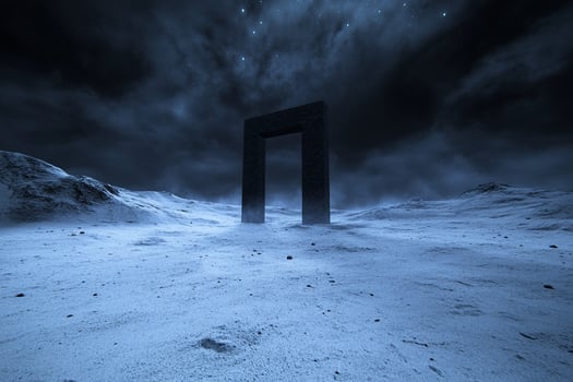 A black door in the middle of a desert photo
