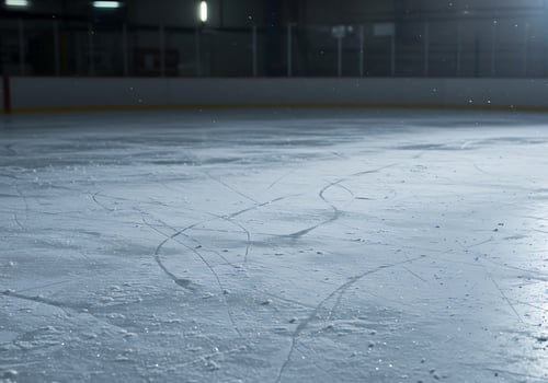 An empty ice rink with a hockey puck on it photo