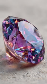Sparkling purple and blue gemstone shines in natural light on a textured surface, showcasing intricate facets and colors photo