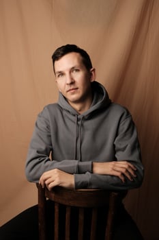 A Casual Portrait of a Man Wearing a Hoodie with an Appealing and Relaxed Attitude photo