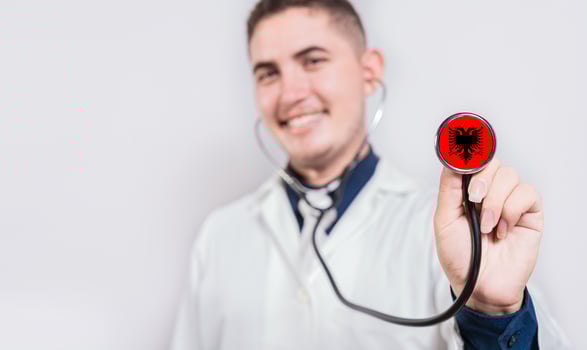 Doctor showing stethoscope with Albania flag. Albania national healthcare concept photo