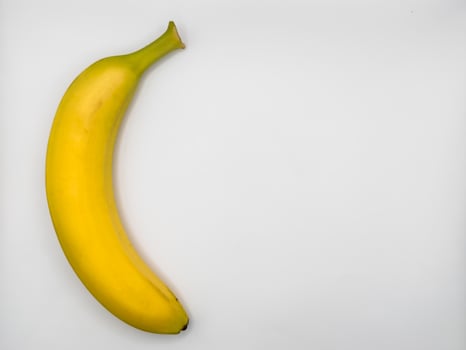 Ripe banana isolated on white background, copy space, flat lay, top view photo