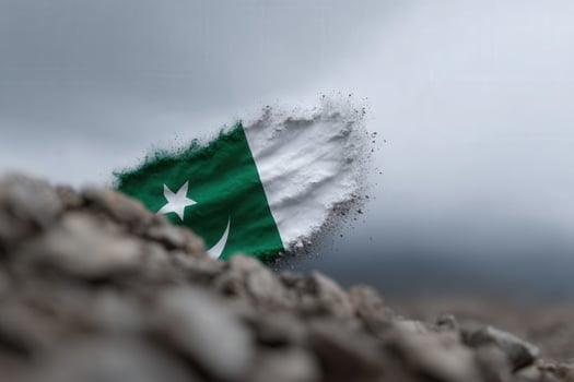 Flag of Pakistan disintegrating against a dramatic gray sky backdrop photo