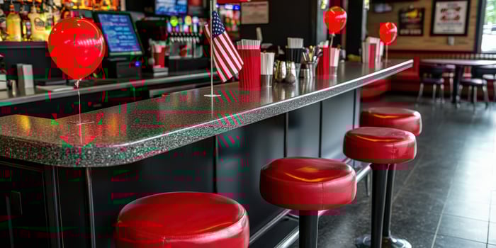 A bar with red stools and balloons photo