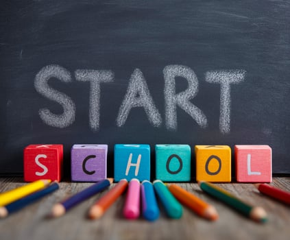 Colorful school supplies with 'Start School' on a chalkboard. photo