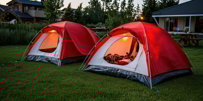 Two tents are set up on the grass photo