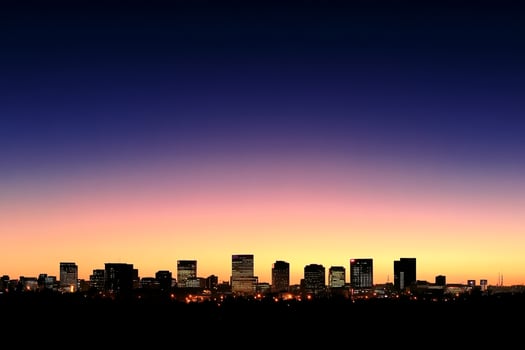 A city skyline at sunset with a blue sky photo