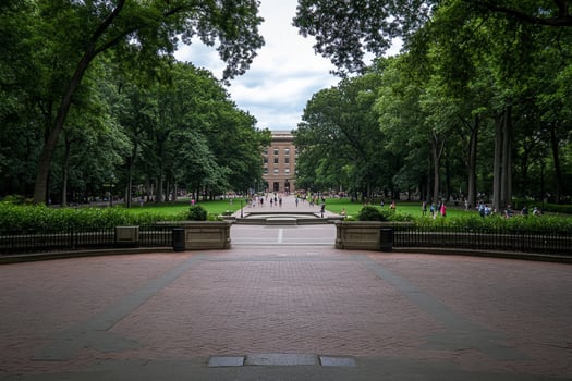 A brick walkway leads to a large building photo