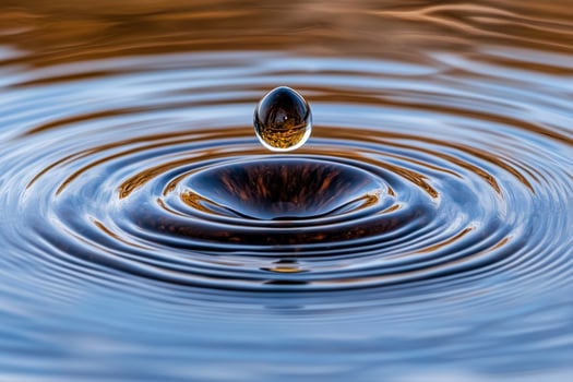 Water drop in the water with a brown background photo