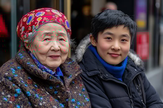 An asian woman and boy sitting on a bench photo