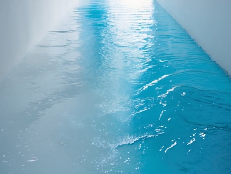 Tranquil Blue Water in a Narrow Channel, Reflecting Light and Creating a Calming Scene. photo