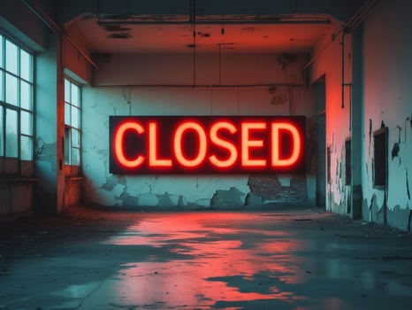 A neon sign that says closed in an empty room photo