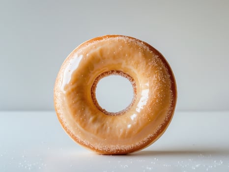 A glazed donut with sugar on top photo
