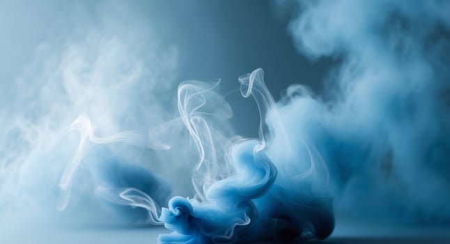 Blue smoke in water on a gray background photo
