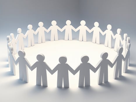 Circle of Paper People Holding Hands, Illustrating Teamwork, Unity and Cooperation. photo