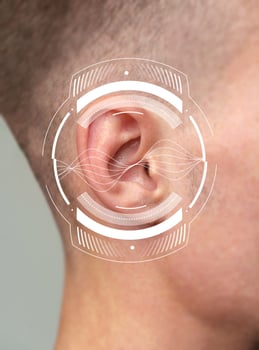 Close-up view of a person's ear with sound wave graphics illustrating hearing concept photo