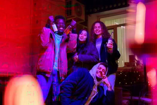 Friends celebrate at a lively gathering in a warmly decorated space at night photo