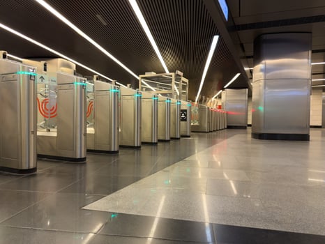 Modern turnstile gate system with illuminated access indicators at metro station, emphasizing advanced public transport infrastructure and automated fare control technology photo