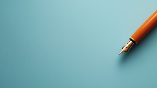 Orange fountain pen on minimalist blue background photo