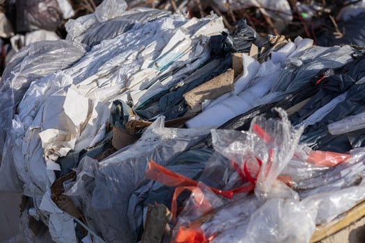 Various types of recyclable materials are stacked together at a waste management facility, showcasing the importance of recycling efforts photo
